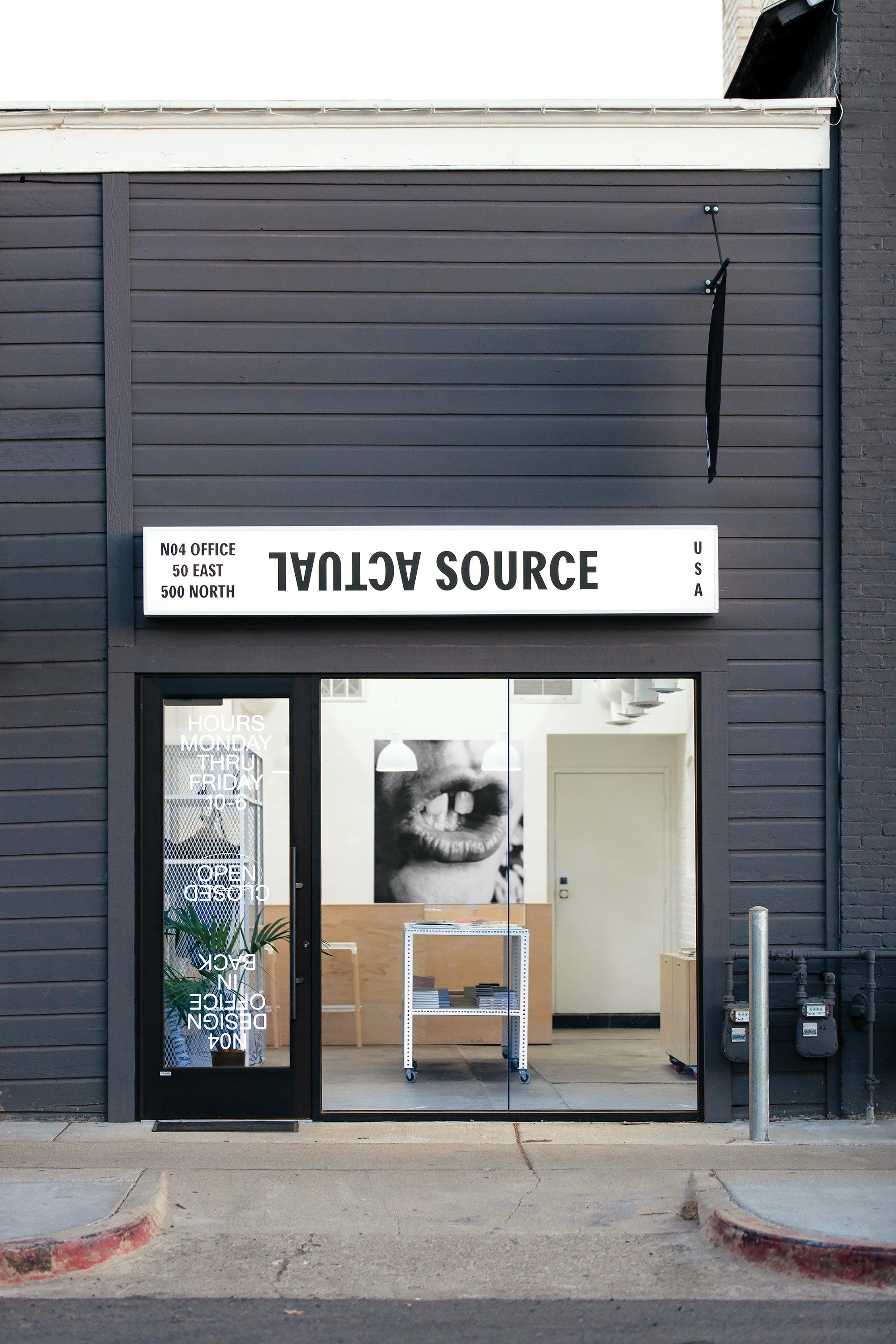 A photo of the Actual Source storefront in the daytime.