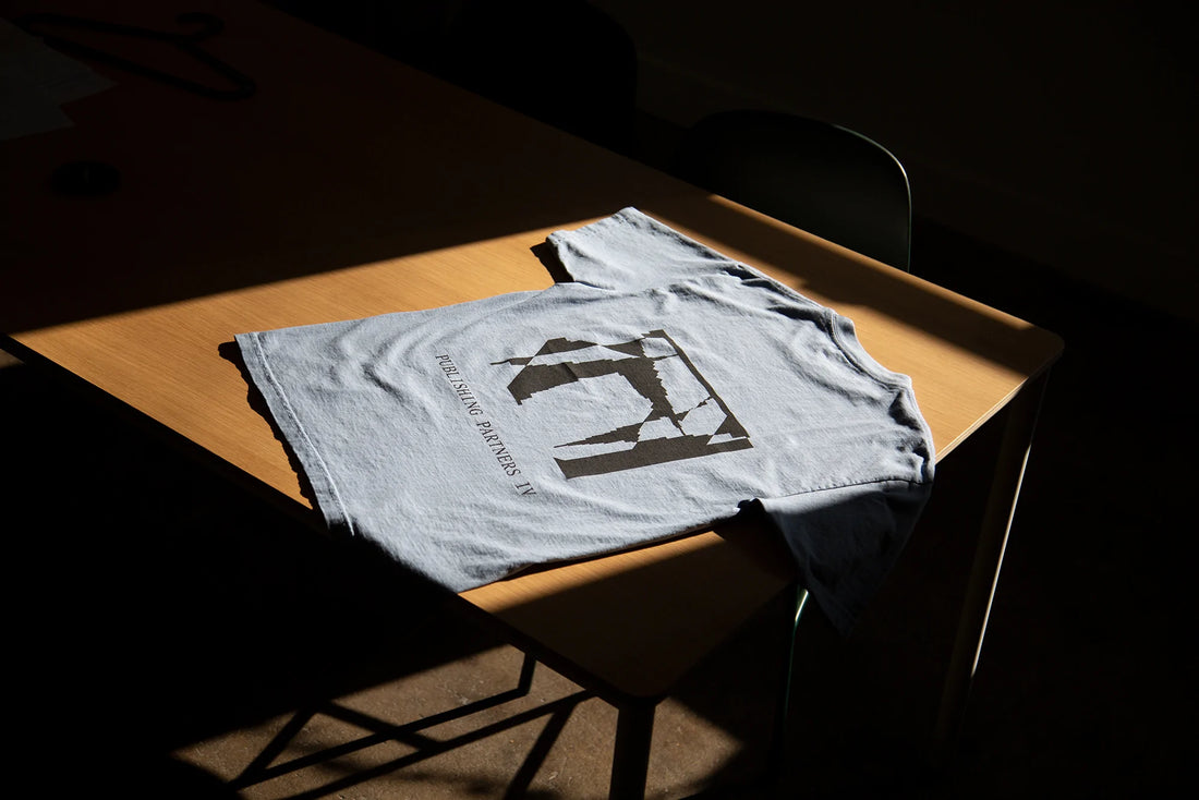 An Actual Source t-shirt on a table.