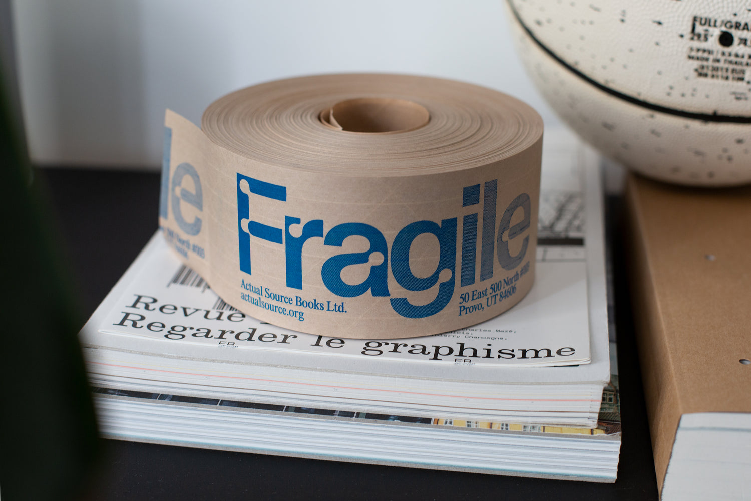 Fragile shipping tape with books.